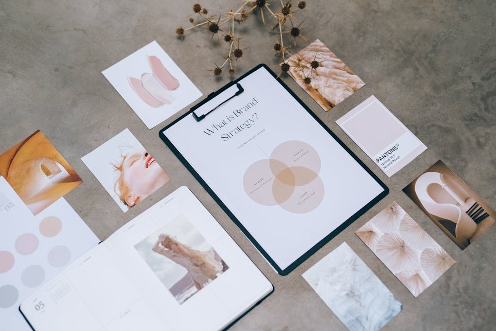 Flat lay of a minimalist brand strategy moodboard on a concrete surface.